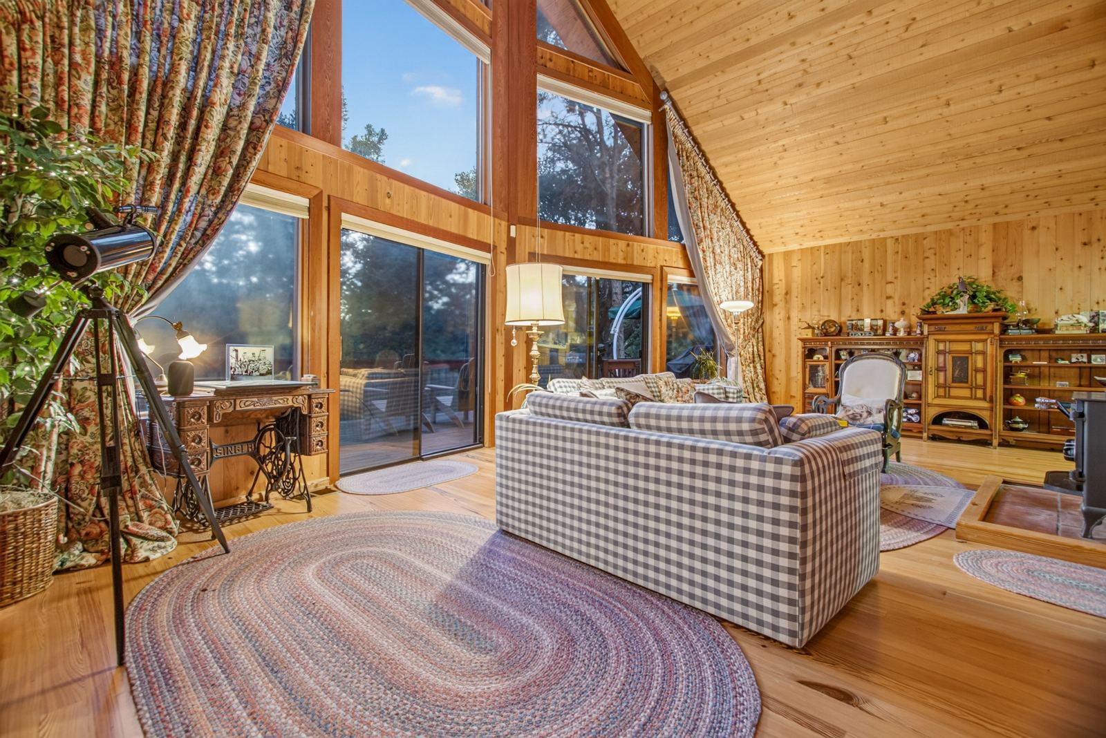 Cedar-lined great room with a wall of glass onto the pines