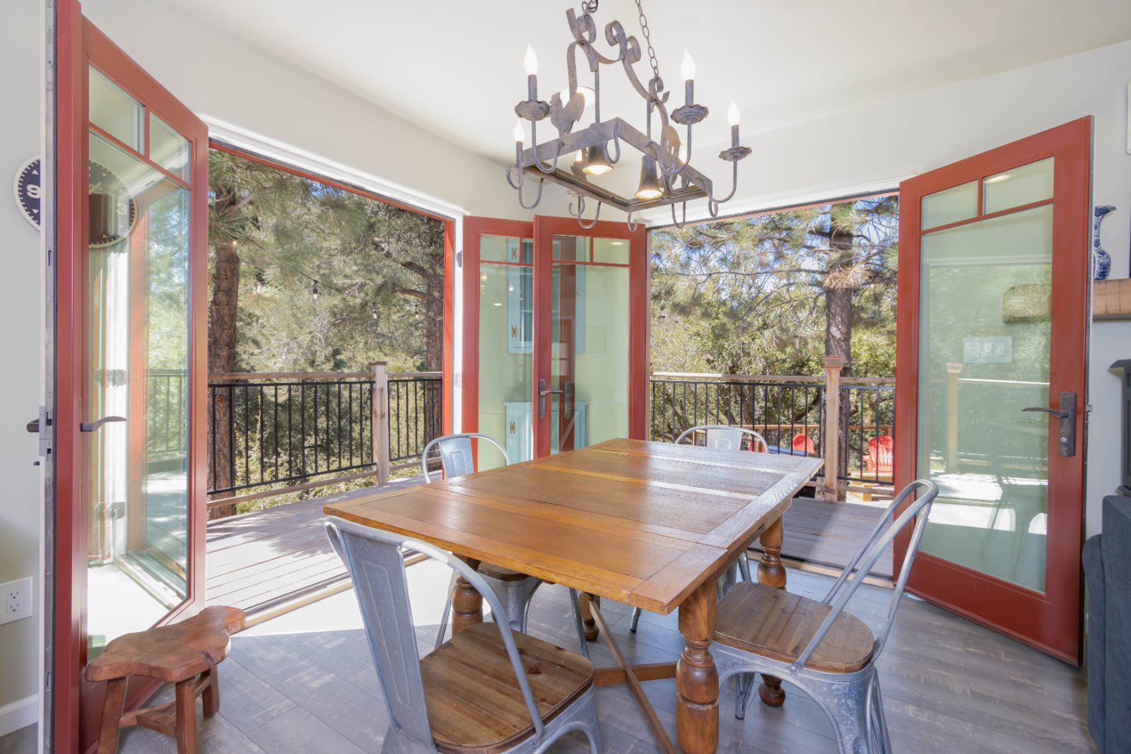 Dining area with red french doors open to a deck