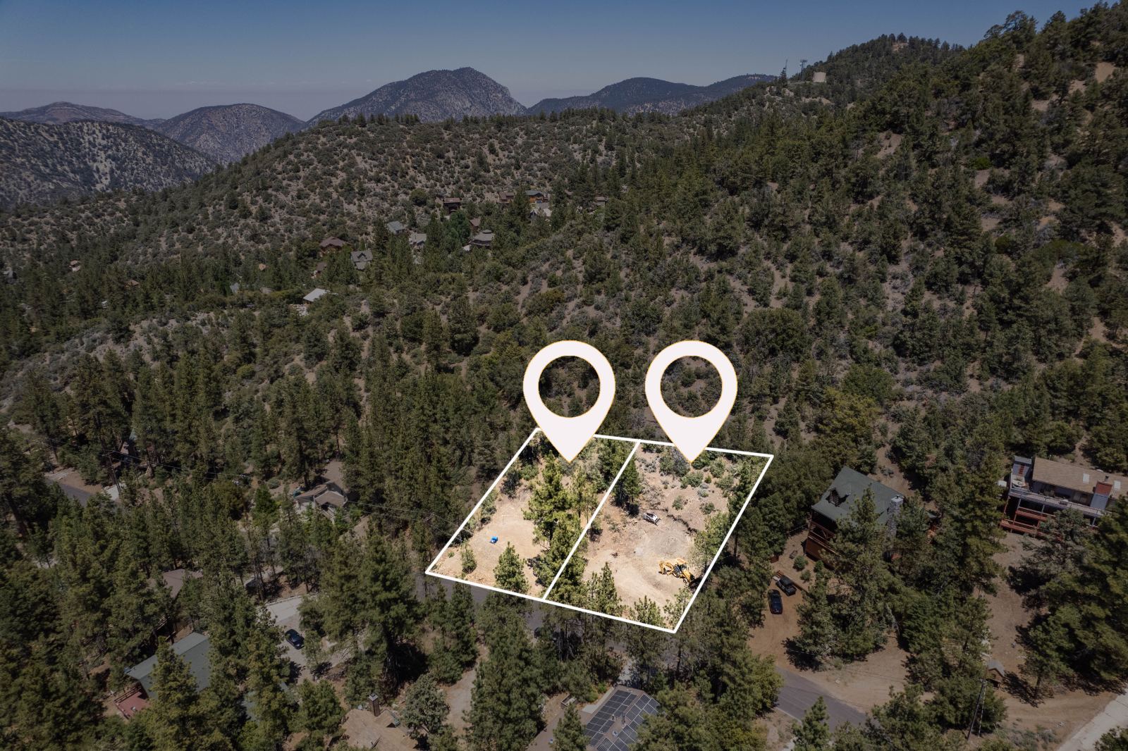 Aerial of two adjacent building lots marked with pins and boundary lines