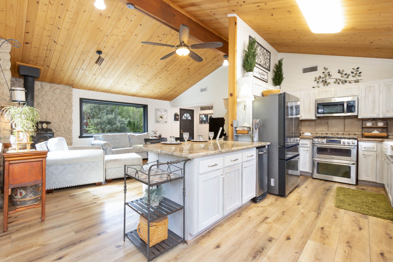 Open kitchen under a vaulted wood ceiling