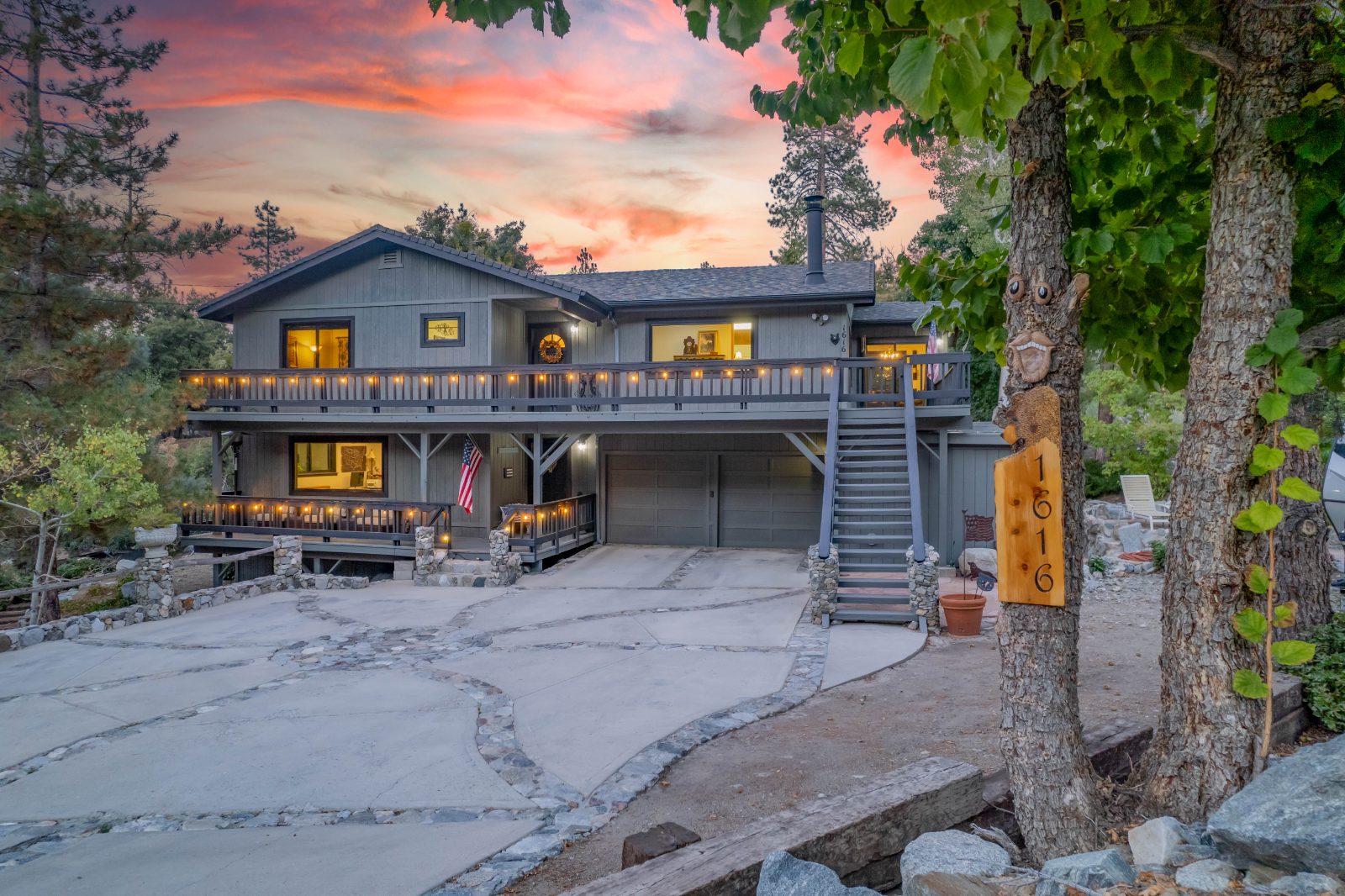 Mountain home at sunset with lit deck